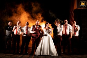 In Essa, Ontario, the bridal party shares a relaxed moment as they smoke together, their laughter and camaraderie evident in the casual outdoor setting.